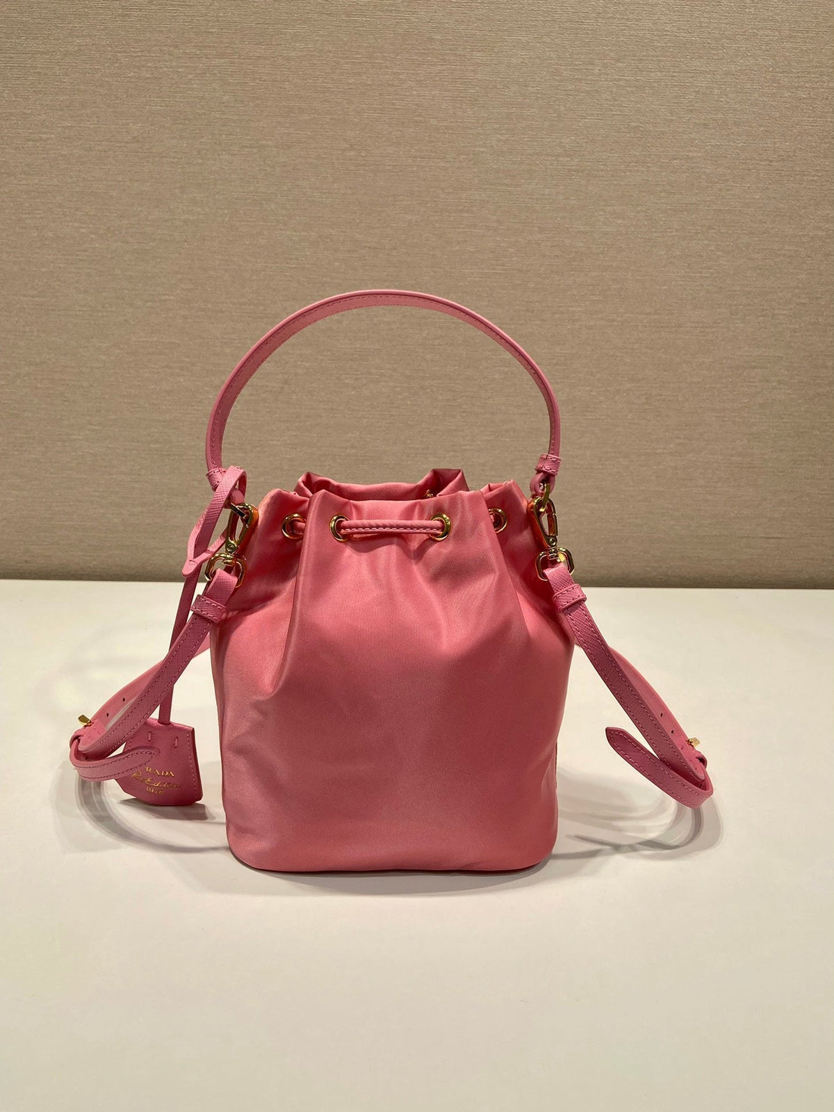 BUCKET BAG 19 IN CANDY PINK RE-NYLON AND SAFFIANO LEATHER HANDLE
