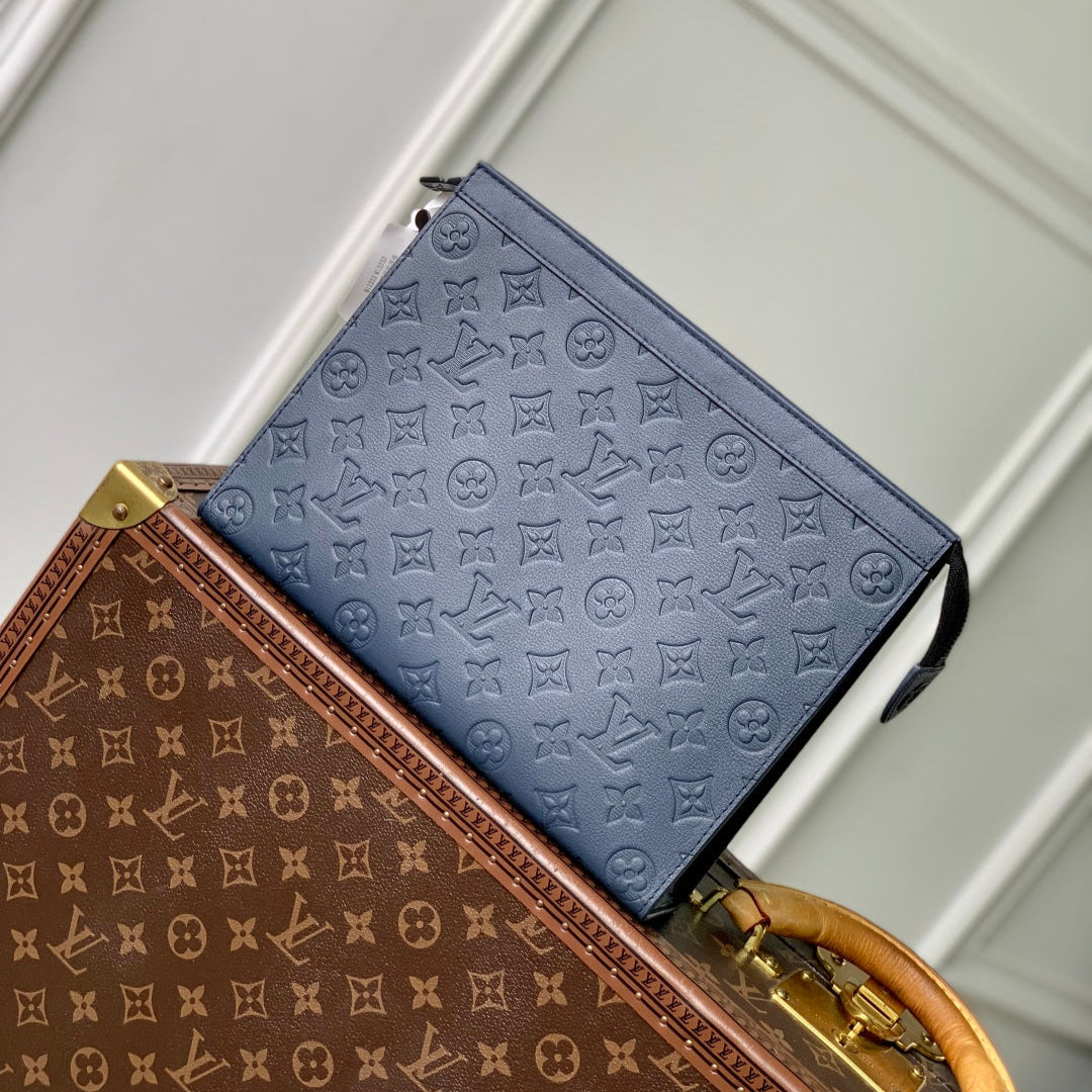 POCHETTE VOYAGE 27 IN DARK BLUE MONOGRAM ECLIPSE CALFSKIN EMBOSSED LOGO