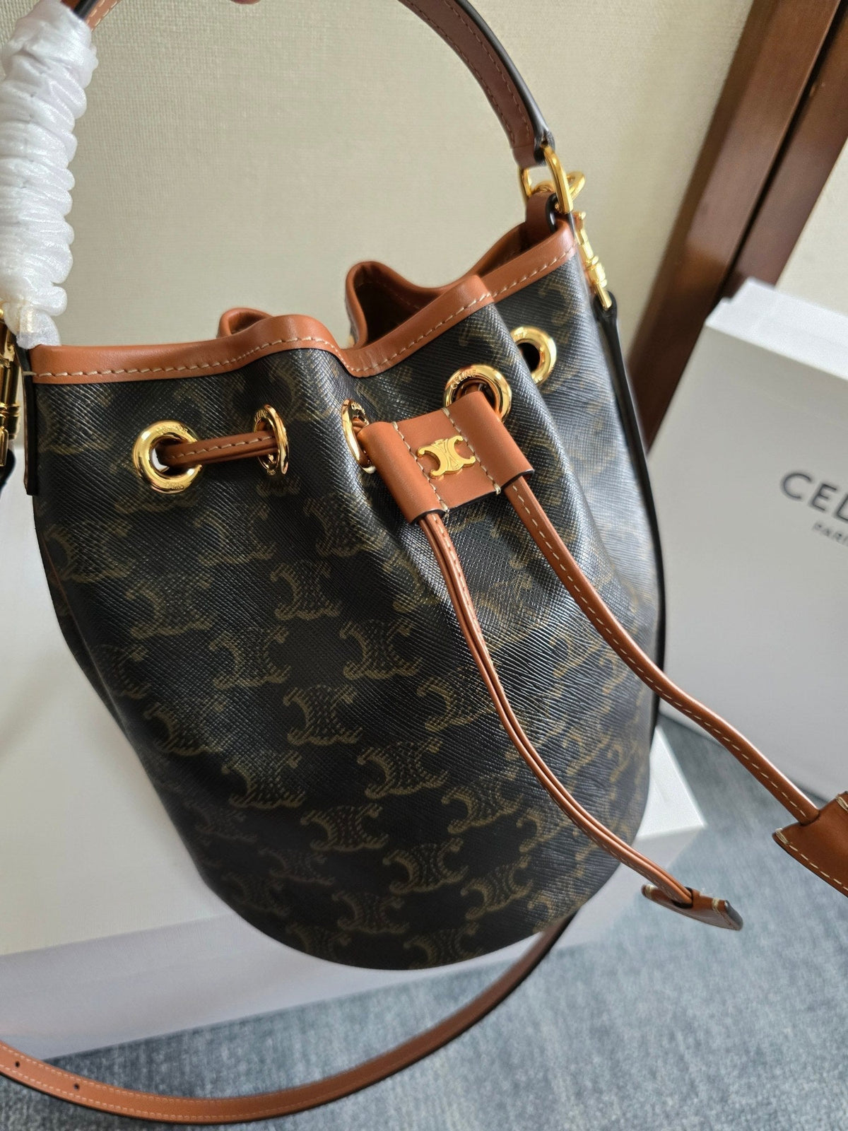 CLARA BAG 19 IN BLACK TRIOMPHE CANVAS AND BROWN CALFSKIN TRIM