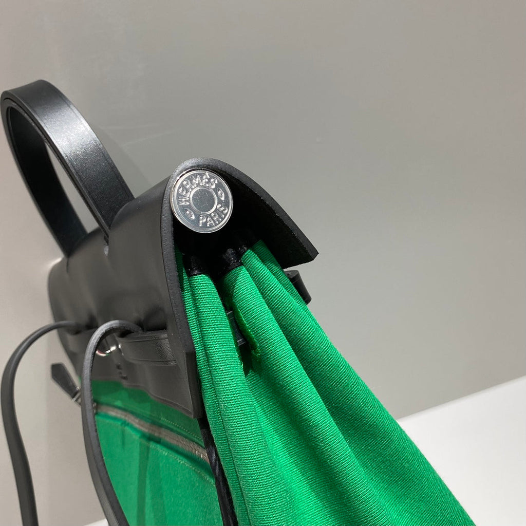 HERBAG A DOS ZIP RETOURNE BACKPACK 29 IN GREEN CANVAS AND BLACK CALFSKIN