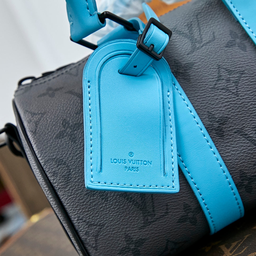 KEEPALL BANDOULIÈRE 25 IN GUN METAL MONOGRAM ECLIPSE CANVAS MIX TURQUOISE CALFSKIN